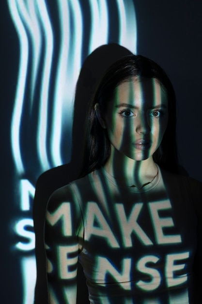 Young woman shooting with projector  medium shot