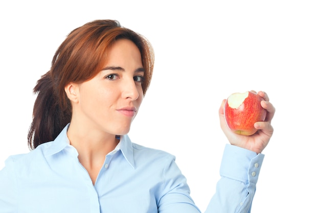 Young woman showing a bitten red apple