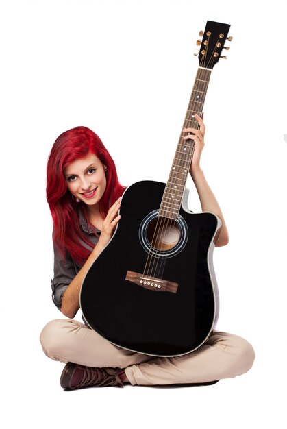 Young woman showing her guitar