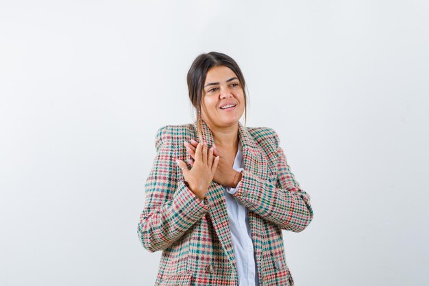 Young woman showing her jacket on white background