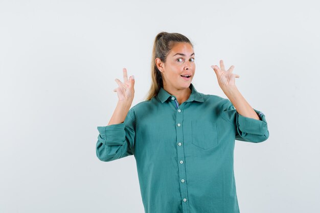 Young woman showing ok signs in green blouse and looking cute