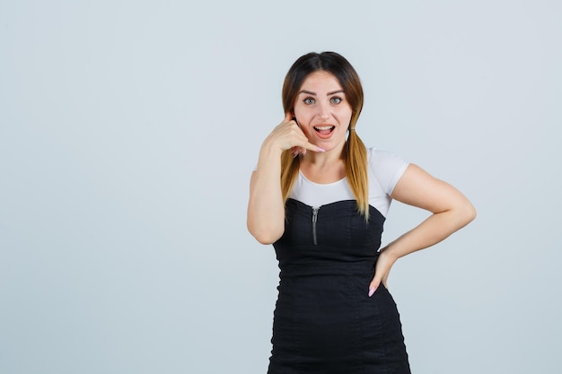 Free photo young woman showing phone gesture