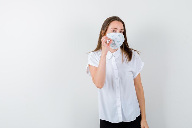 Young woman showing shush gesture