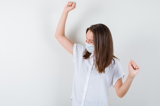 Young woman showing winner gesture