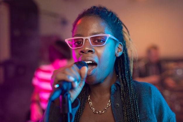 Young woman singing at a local event