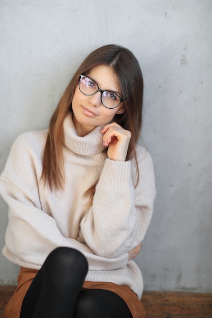 young woman sitting on the floor and posing