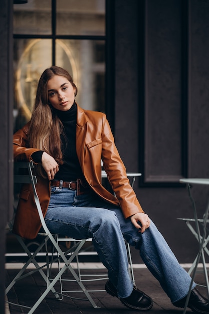 Young woman sitting outside the bar