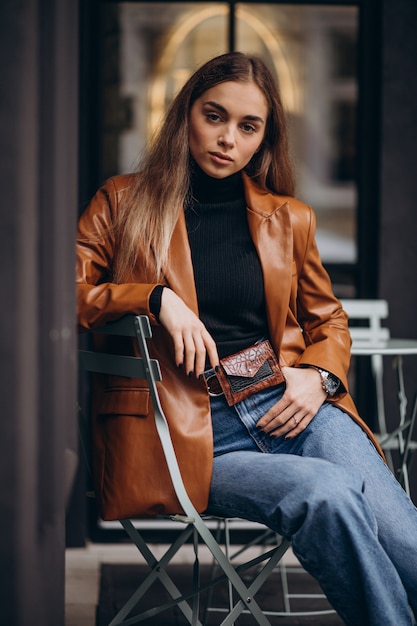 Young woman sitting outside the bar