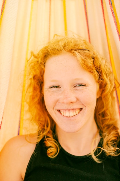 Free Photo young woman smiling while looking at camera