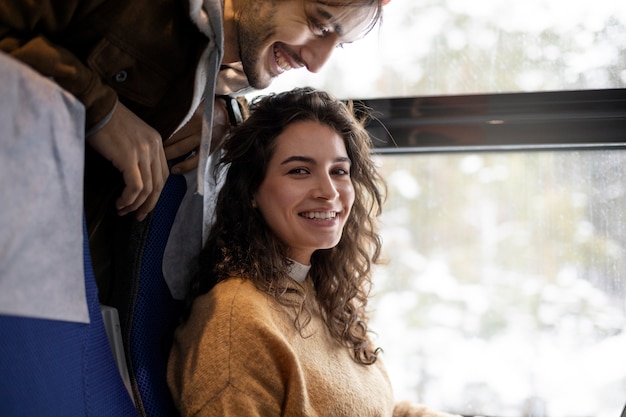 Free photo young woman smiling while traveling by train