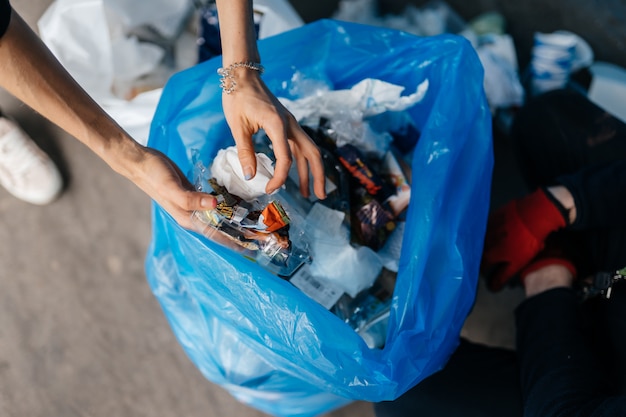 Young woman sorting garbage. Concept of recycling. Zero waste