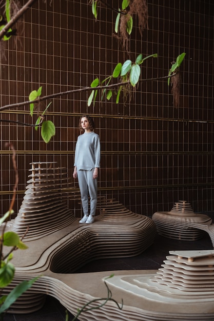 Free photo young woman standing on an art platform