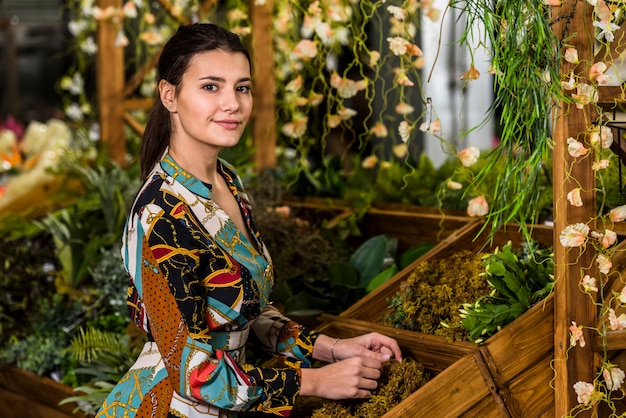 Young woman standing in green house 