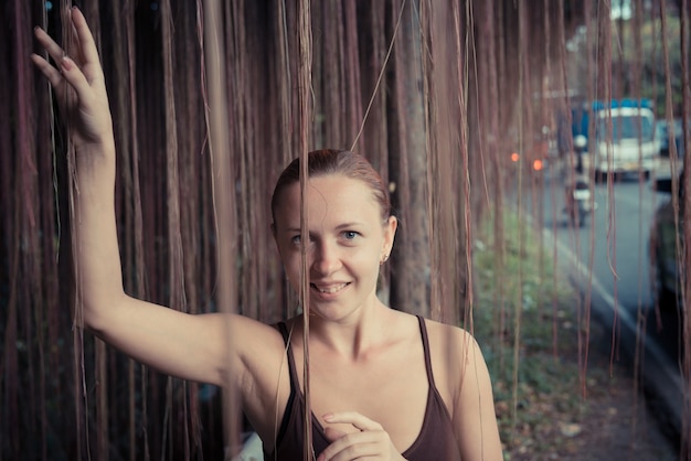 Young woman standing in thick jungle vegetation