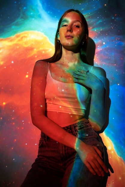 Young woman standing in universe texture projection