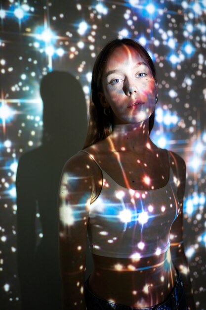 Young woman standing in universe texture projection