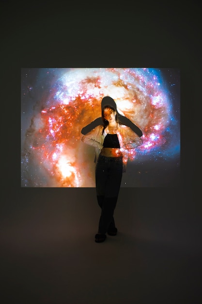 Free Photo young woman standing in universe texture projection