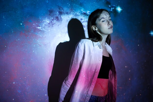 Young woman standing in universe texture projection