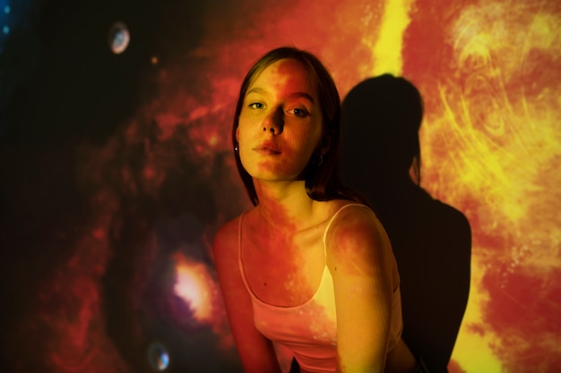 Young woman standing in universe texture projection