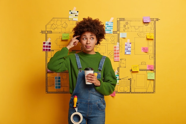 Free Photo young woman stands next to house design sketch ready for renovation