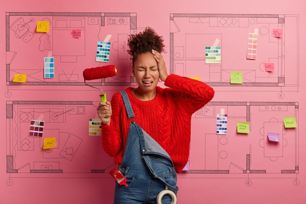 Free Photo young woman stands next to house design sketch ready for renovation