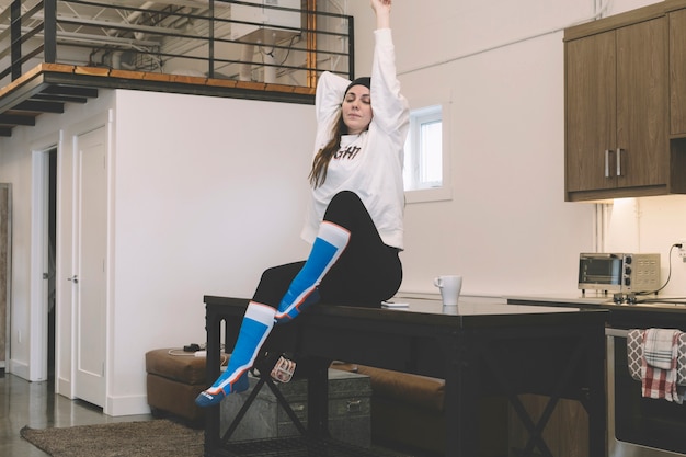 Free photo young woman stretching herself in morning