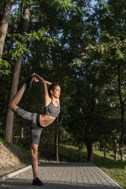 Young woman stretching in the park