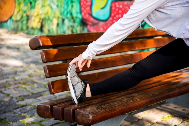 Young woman stretching at the street