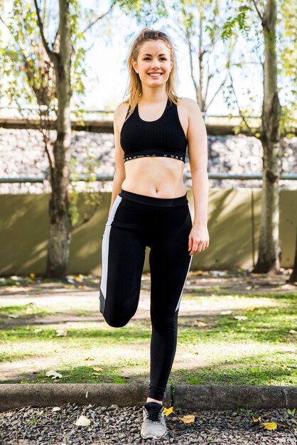 Young woman stretching at the street