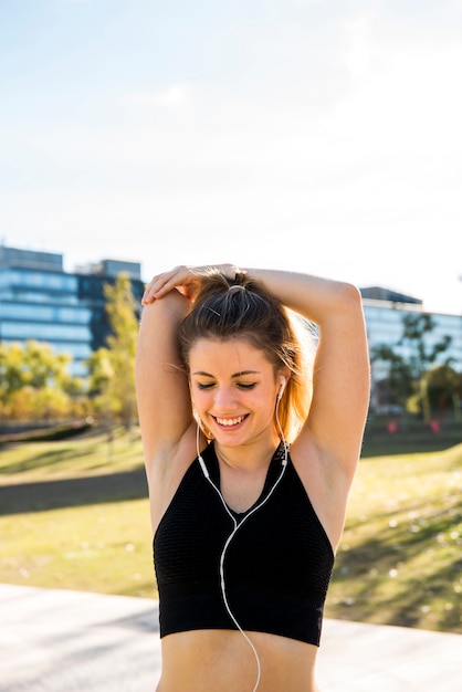 Young woman stretching at the street