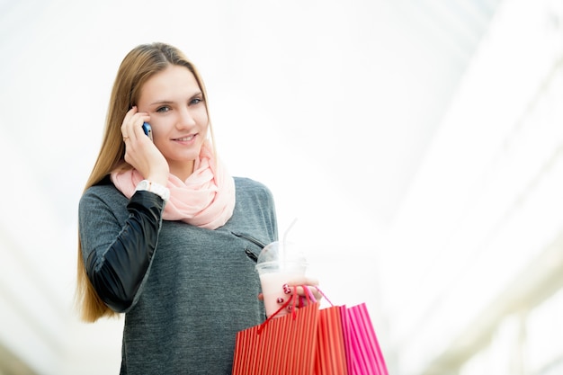 Free photo young woman in supermarket making a call