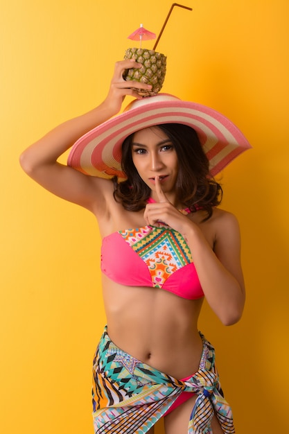 Free photo young woman in swimwear isolated over yellow