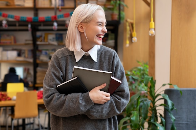 Young woman taking books from a library to use for studying