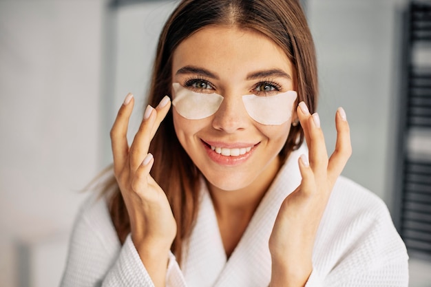 Young woman taking care of her face