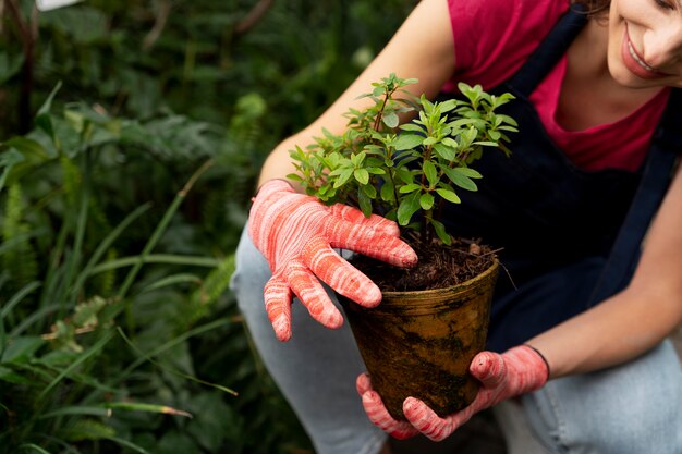 Young woman taking care of her plants