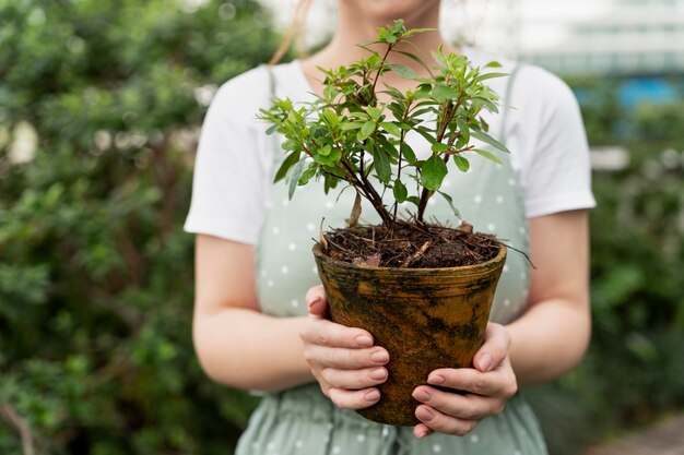 Young woman taking care of her plants