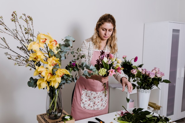 Young woman taking flowers for bunch