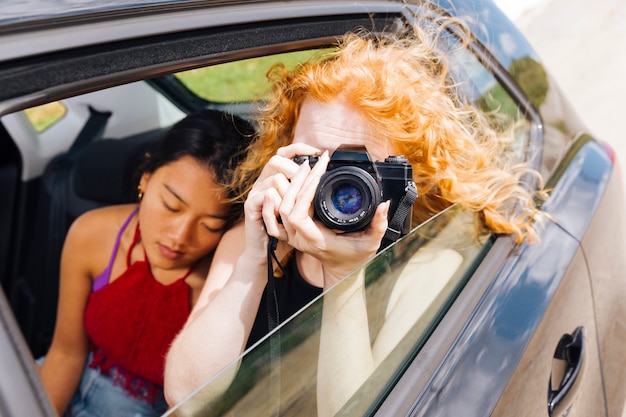 Free Photo young woman taking pictures on camera