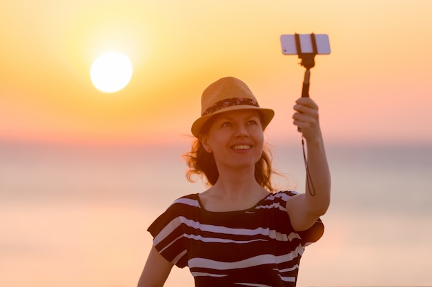 Free Photo young woman taking self-photo with sea view