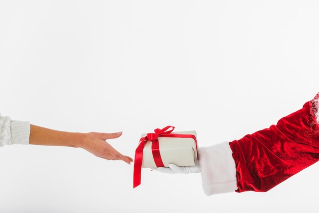 Young woman taking small gift box at Santa Claus