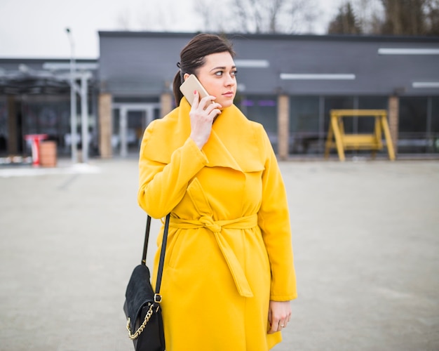 Free Photo young woman talking on cellphone