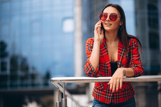 Young woman talking on the phone by the office center