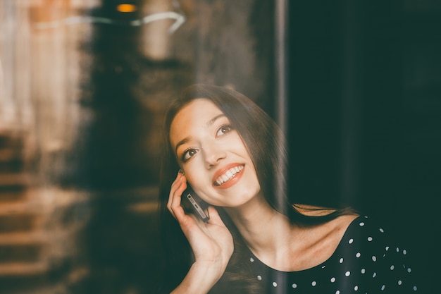 Young woman talking on the phone with a big smile