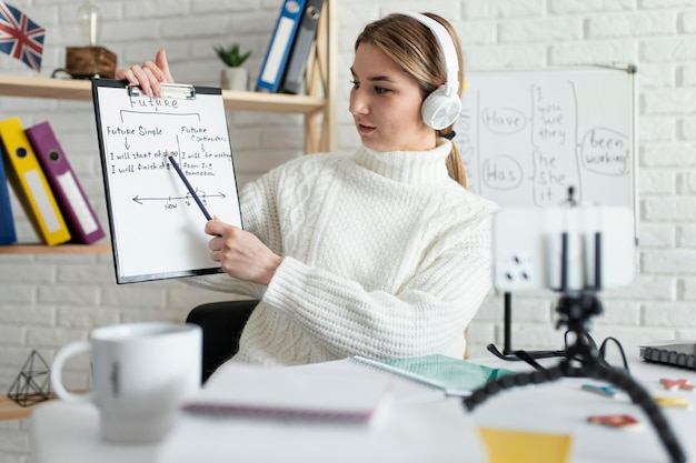 Free photo young woman teaching kids an english lesson online