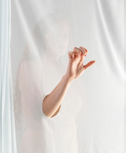 Free photo young woman teaching sign language