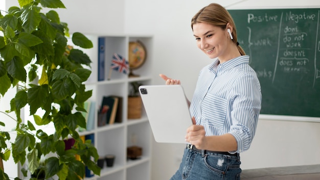 Young woman teaching students in english class online