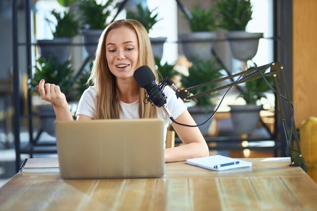 Young woman telling information in live broadcast