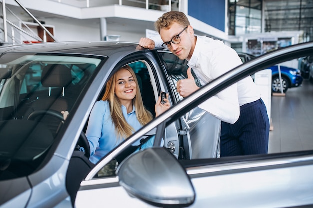 Free Photo young woman testing a car from a car showroom