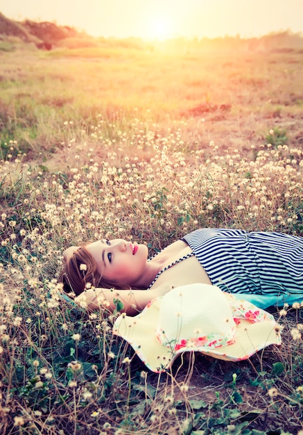 Free photo young woman thinking at sunset