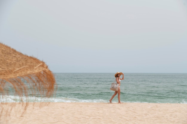 Free Photo young woman traveling without covid by the sea